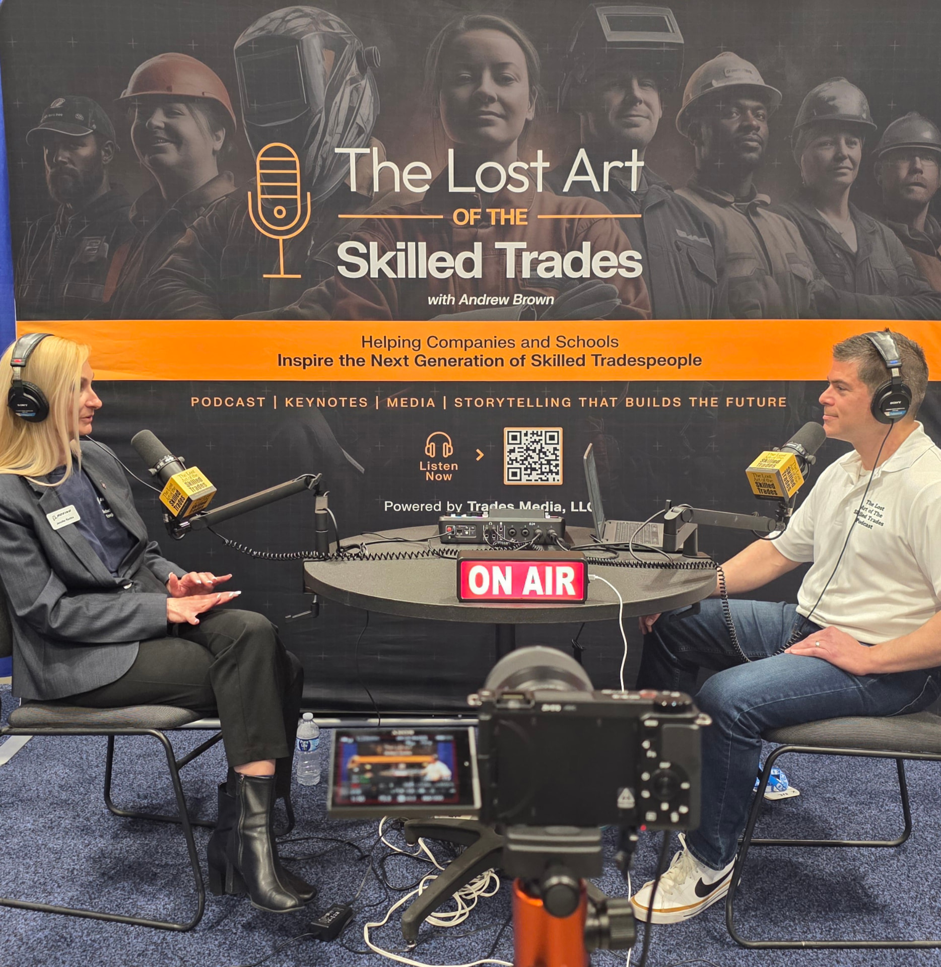 Andrew Brown recording The Lost Art of the Skilled Trades podcast with a guest at an event
