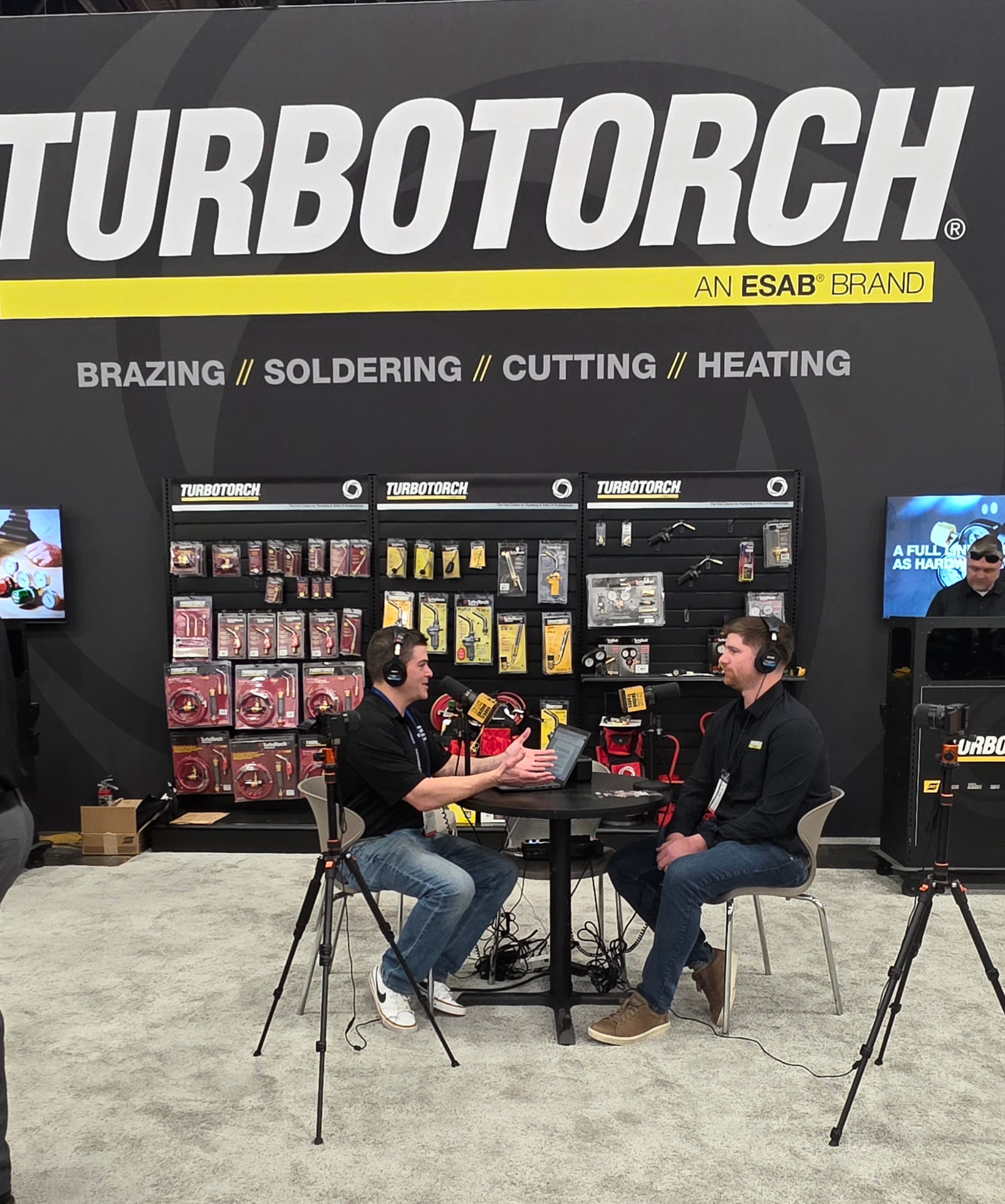 Andrew Brown recording a live podcast interview at a TurboTorch booth